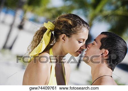 Close-up of a mid adult man and a young woman kissing View Large Photo Image Stock Image - Close-up of a mid adult man and a young woman kissing. Fotosearch