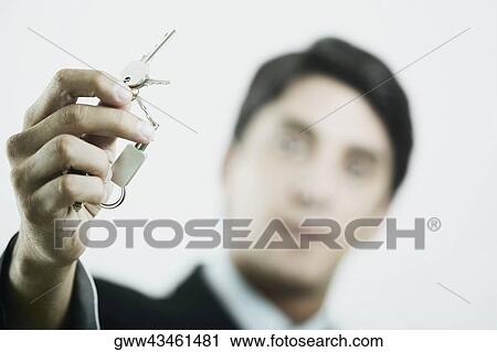 Close-up of a mid adult man holding a key ring View Large Photo Image Stock Image - Close-up of a mid adult man holding a key ring. Fotosearch