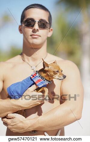 Close-up of a mid adult man holding a puppy View Large Photo Image Stock Image - Close-up of a mid adult man holding a puppy. Fotosearch