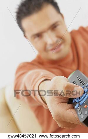 Close-up of a mid adult man operating a remote control View Large Photo Image Stock Image - Close-up of a mid adult man operating a remote control. Fotosearch