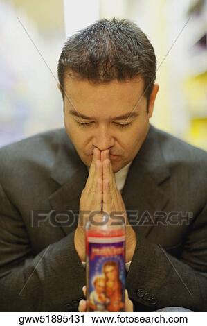 Close-up of a mid adult man praying View Large Photo Image Stock Image - Close-up of a mid adult man praying. Fotosearch