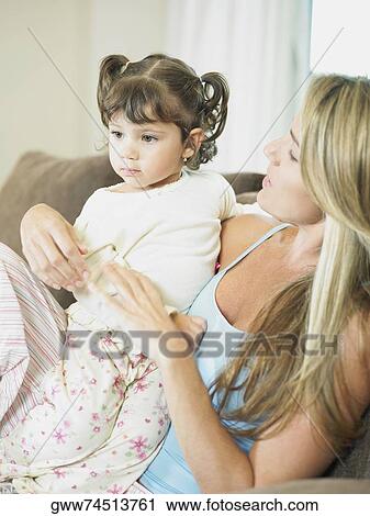 Close-up of a mid adult woman with her daughter View Large Photo Image Stock Image - Close-up of a mid adult woman with her daughter. Fotosearch