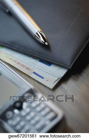 Close-up of a mobile phone and a diary on the table View Large Photo Image Stock Image - Close-up of a mobile phone and a diary on the table. Fotosearch