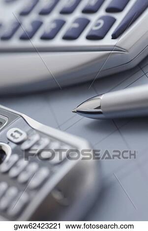 Close-up of a mobile phone with a ballpoint pen and a calculator View Large Photo Image Stock Image - Close-up of a mobile phone with a ballpoint pen and a calculator. Fotosearch