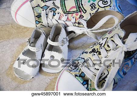 Close-up of a pair of sandals with a pair of shoes View Large Photo Image Stock Image - Close-up of a pair of sandals with a pair of shoes. Fotosearch