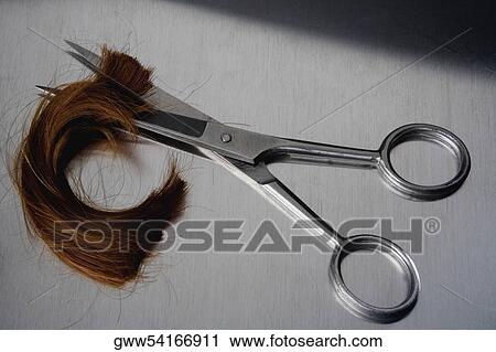 Close-up of a pair of scissors cutting hair View Large Photo Image Stock Image - Close-up of a pair of scissors cutting hair. Fotosearch