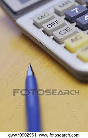 Close-up of a pen and a calculator View Large Photo Image Stock Image - Close-up of a pen and a calculator. Fotosearch