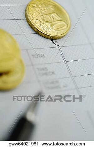 Close-up of a pen and coins on a financial document View Large Photo Image Stock Image - Close-up of a pen and coins on a financial document. Fotosearch