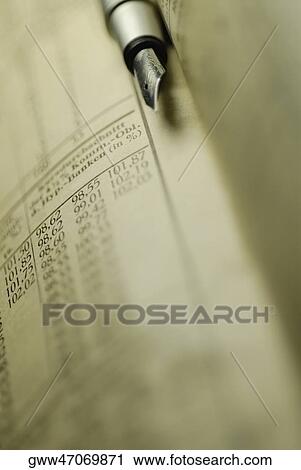 Close-up of a pen on a financial document View Large Photo Image Stock Image - Close-up of a pen on a financial document. Fotosearch