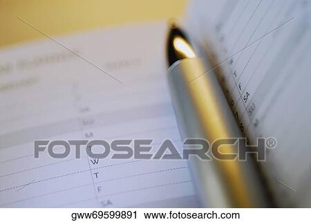 Stock Image - Close-up of a pen with a diary. Fotosearch