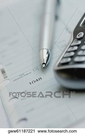 Close-up of a pen with a mobile phone on a tax form View Large Photo Image Stock Image - Close-up of a pen with a mobile phone on a tax form. Fotosearch