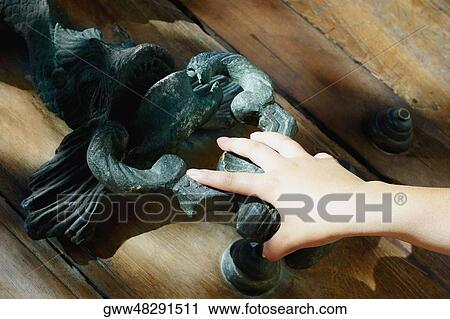 Close-up of a person's hand holding a doorknocker View Large Photo Image Stock Image - Close-up of a person's hand holding a doorknocker. Fotosearch