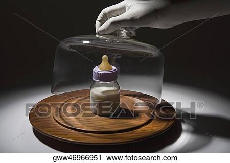 Close-up of a person's hand removing a glass container over a baby bottle View Large Photo Image Stock Image - Close-up of a person's hand removing a glass container over a baby bottle. Fotosearch