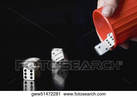 Close-up of a person's hand throwing dice from a cup View Large Photo Image Stock Image - Close-up of a person's hand throwing dice from a cup. Fotosearch