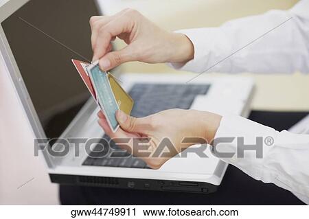 Close-up of a person's hands holding credit cards View Large Photo Image Stock Image - Close-up of a person's hands holding credit cards. Fotosearch