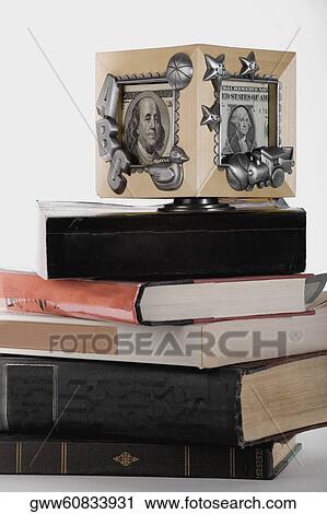 Close-up of a picture frame on a stack of books View Large Photo Image Stock Image - Close-up of a picture frame on a stack of books. Fotosearch