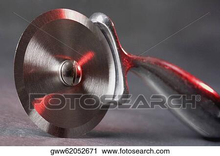 Stock Image - Close-up of a pizza cutter. Fotosearch