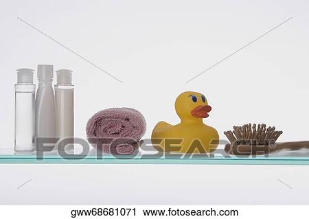 Close-up of a rubber duck with toiletries on a glass shelf View Large Photo Image Stock Image - Close-up of a rubber duck with toiletries on a glass shelf. Fotosearch
