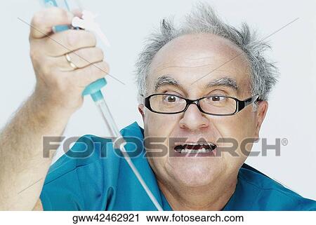 Close-up of a senior man holding an iv drip and making a face View Large Photo Image Stock Image - Close-up of a senior man holding an iv drip and making a face. Fotosearch