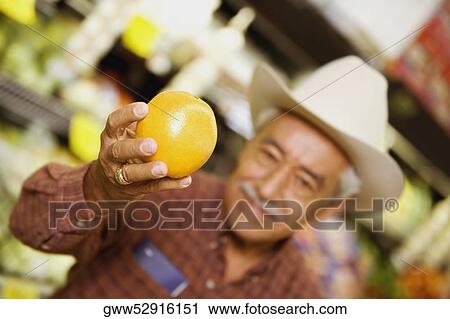 Close-up of a senior man holding an orange View Large Photo Image Stock Image - Close-up of a senior man holding an orange. Fotosearch