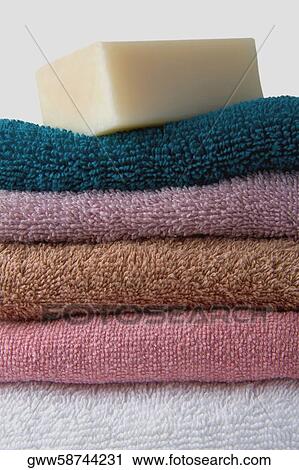 Close-up of a stack of towels with a bar of soap View Large Photo Image Stock Image - Close-up of a stack of towels with a bar of soap. Fotosearch