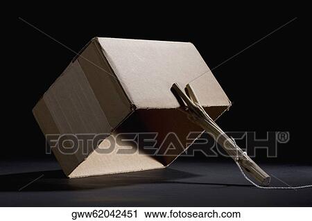 Stock Image - Close-up of a stick holding up a carton. Fotosearch