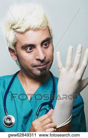 Close-up of a surgeon wearing surgical gloves View Large Photo Image Stock Image - Close-up of a surgeon wearing surgical gloves. Fotosearch