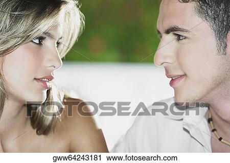 Close-up of a teenage boy looking at a young woman View Large Photo Image Stock Image - Close-up of a teenage boy looking at a young woman. Fotosearch