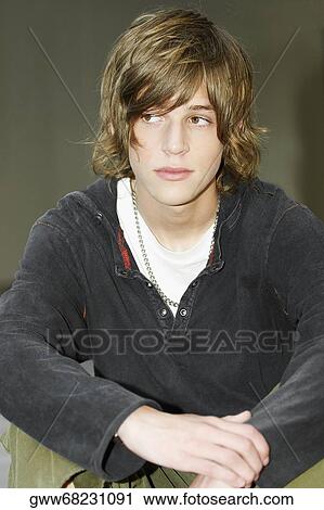 Close-up of a teenage boy sitting with his hands on his knees View Large Photo Image Stock Image - Close-up of a teenage boy sitting with his hands on his knees. Fotosearch