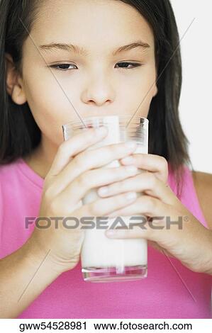 Close-up of a teenage girl holding a glass of milk View Large Photo Image Stock Image - Close-up of a teenage girl holding a glass of milk. Fotosearch