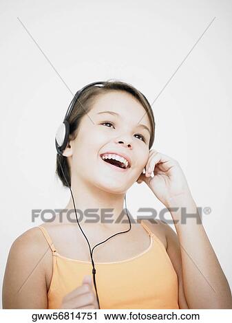 Stock Image - Close-up of a teenage girl listening to music. Fotosearch