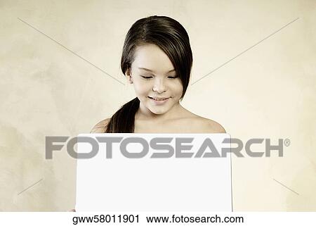 Close-up of a teenage girl looking at a laptop and smiling View Large Photo Image Stock Image - Close-up of a teenage girl looking at a laptop and smiling. Fotosearch