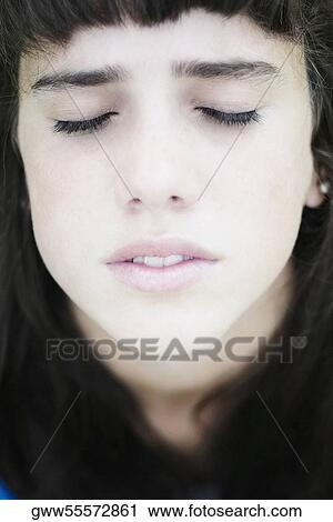 Close-up of a teenage girl thinking with her eyes closed View Large Photo Image Stock Image - Close-up of a teenage girl thinking with her eyes closed. Fotosearch
