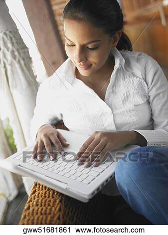 Close-up of a teenage girl using a laptop View Large Photo Image Stock Image - Close-up of a teenage girl using a laptop. Fotosearch