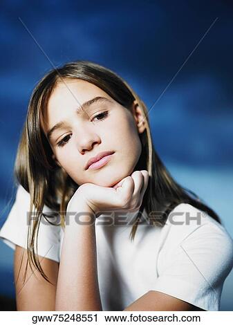 Close-up of a teenage girl with her hand on her chin View Large Photo Image Stock Image - Close-up of a teenage girl with her hand on her chin. Fotosearch