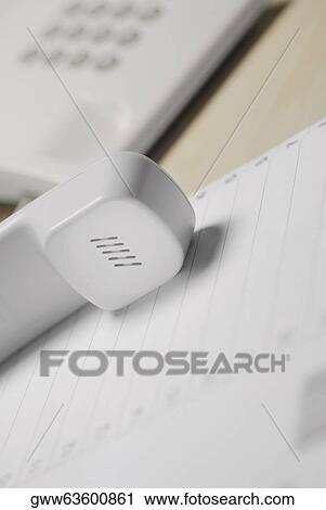 Close-up of a telephone receiver on a document View Large Photo Image Stock Image - Close-up of a telephone receiver on a document. Fotosearch