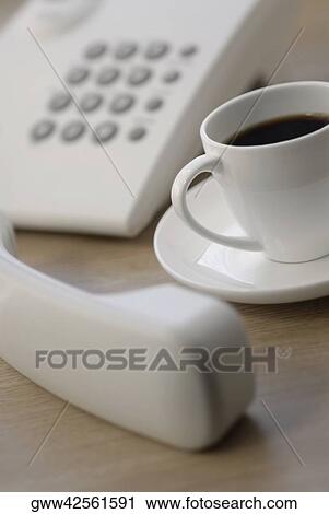 Close-up of a telephone receiver with a cup of tea View Large Photo Image Stock Image - Close-up of a telephone receiver with a cup of tea. Fotosearch