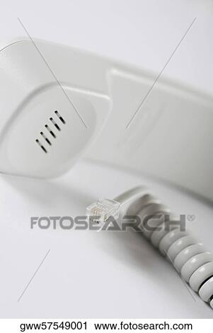Stock Image - Close-up of a telephone receiver with a spiral wire. Fotosearch