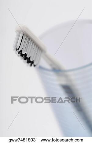 Close-up of a toothbrush in a glass View Large Photo Image Stock Image - Close-up of a toothbrush in a glass. Fotosearch