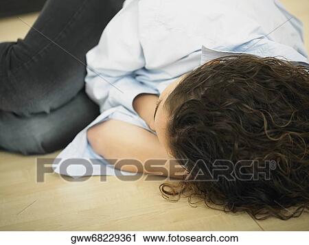 Close-up of a woman lying on the floor View Large Photo Image Stock Image - Close-up of a woman lying on the floor. Fotosearch