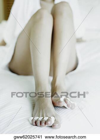 Stock Image - Close-up of a woman wearing a toe divider. Fotosearch