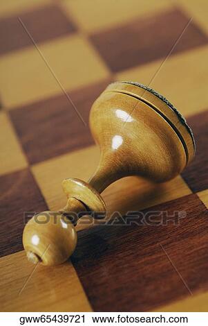 Close-up of a wooden chess piece on a chessboard View Large Photo Image Stock Image - Close-up of a wooden chess piece on a chessboard. Fotosearch