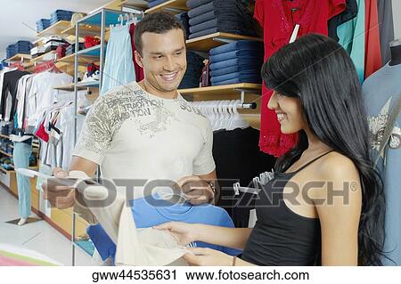 Close-up of a young couple in a clothing store View Large Photo Image Stock Image - Close-up of a young couple in a clothing store. Fotosearch