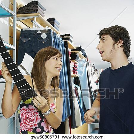 Close-up of a young couple in a clothing store View Large Photo Image Stock Image - Close-up of a young couple in a clothing store. Fotosearch
