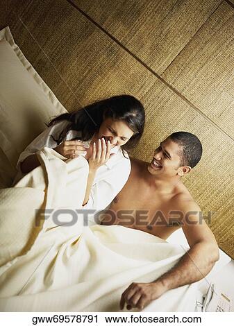 Stock Image - Close-up of a young couple laughing. Fotosearch
