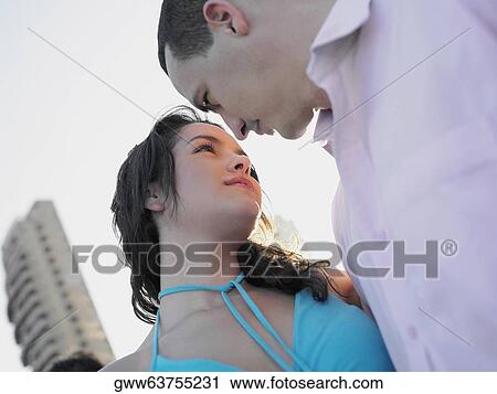 Close-up of a young couple looking at each other View Large Photo Image Stock Image - Close-up of a young couple looking at each other. Fotosearch