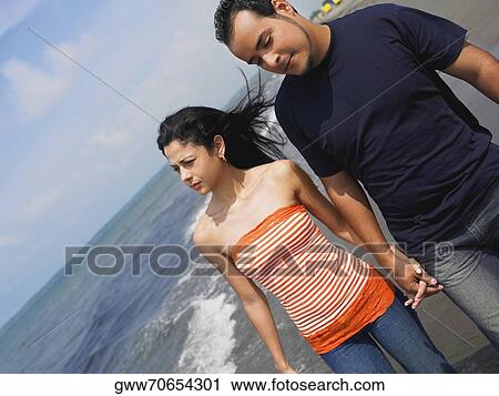 Close-up of a young couple walking on the beach View Large Photo Image Stock Image - Close-up of a young couple walking on the beach. Fotosearch