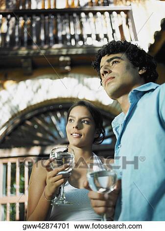 Close-up of a young man and a teenage girl holding glasses of wine View Large Photo Image Stock Image - Close-up of a young man and a teenage girl holding glasses of wine. Fotosearch