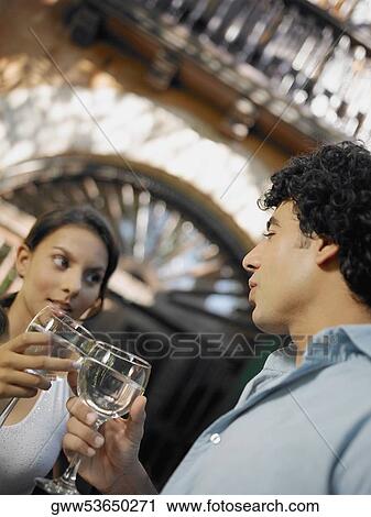 Close-up of a young man and a teenage girl toasting glasses of wine View Large Photo Image Stock Image - Close-up of a young man and a teenage girl toasting glasses of wine. Fotosearch