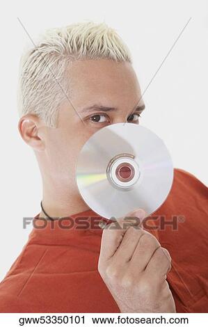 Stock Image - Close-up of a young man holding a CD. Fotosearch